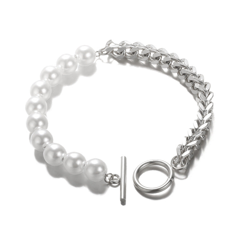 Elegant pearl and chain bracelet for women, featuring a toggle closure and modern design.