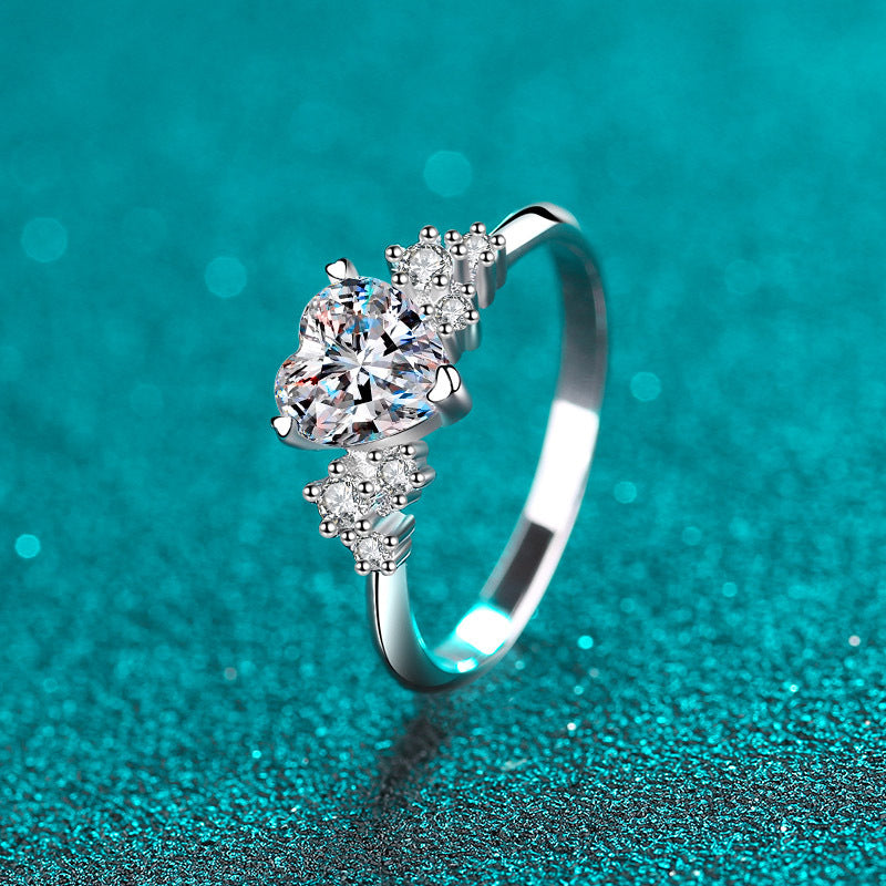 Heart moissanite engagement ring in 925 sterling silver with a 1 karat heart-shaped stone and sparkling accents.