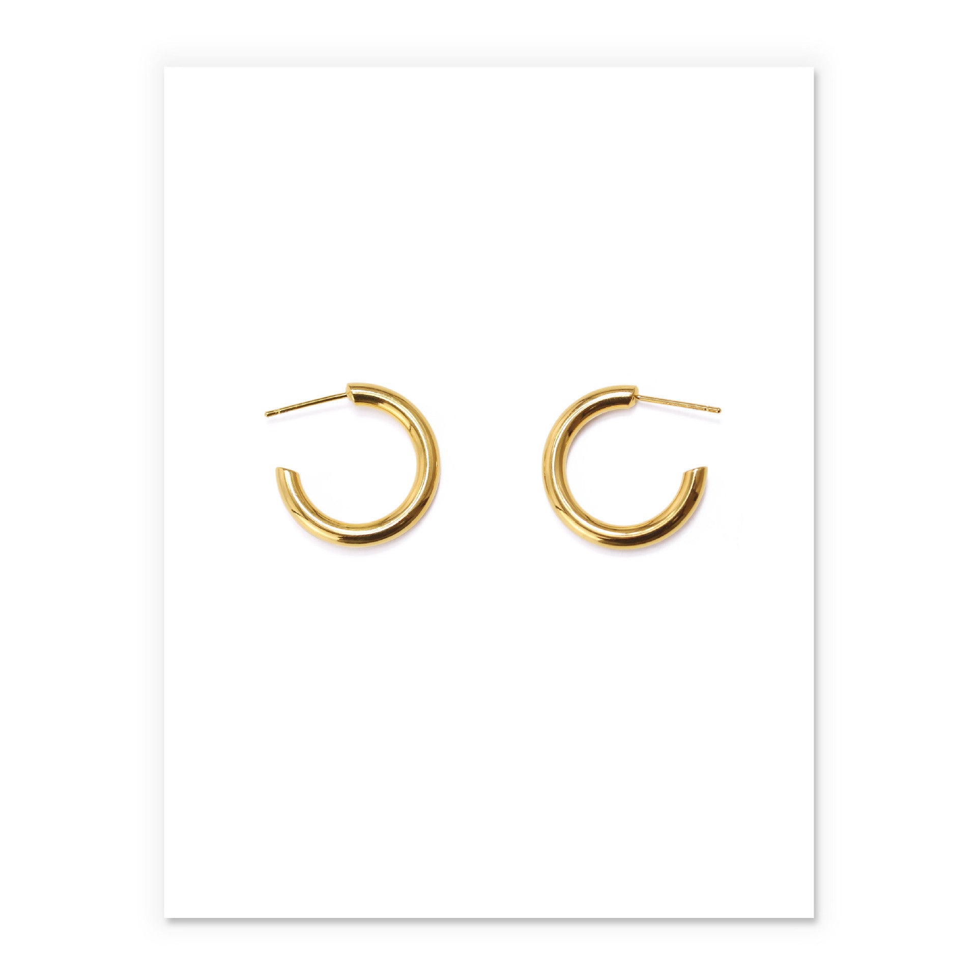Minimalist brass hoop earrings in gold, perfect for adding elegance to any outfit for modern women.