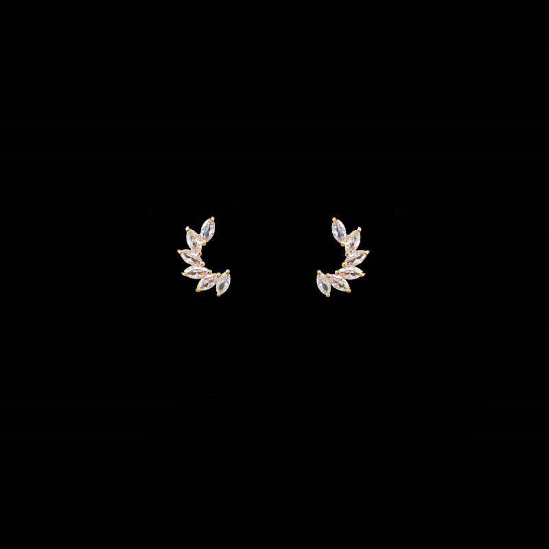 daily wear zirconia stud earrings with a stylish leaf design against a black background.