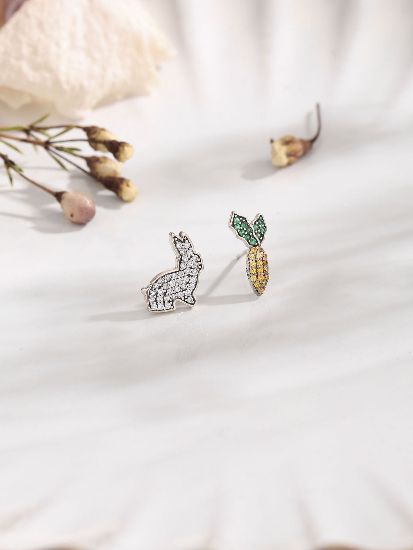Rabbit and Carrot Silver Earrings featuring sparkling gems on a marble surface, perfect for playful elegance.