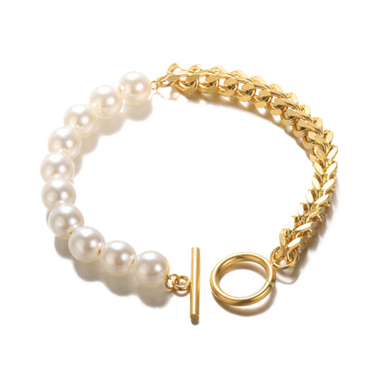 Stainless steel OT buckle bracelet for women in gold with faux pearls and chain design.