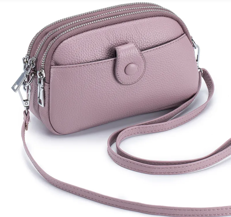 New leather fashion mobile phone bag in soft pink hue with multiple zippers and adjustable strap, perfect for daily use.