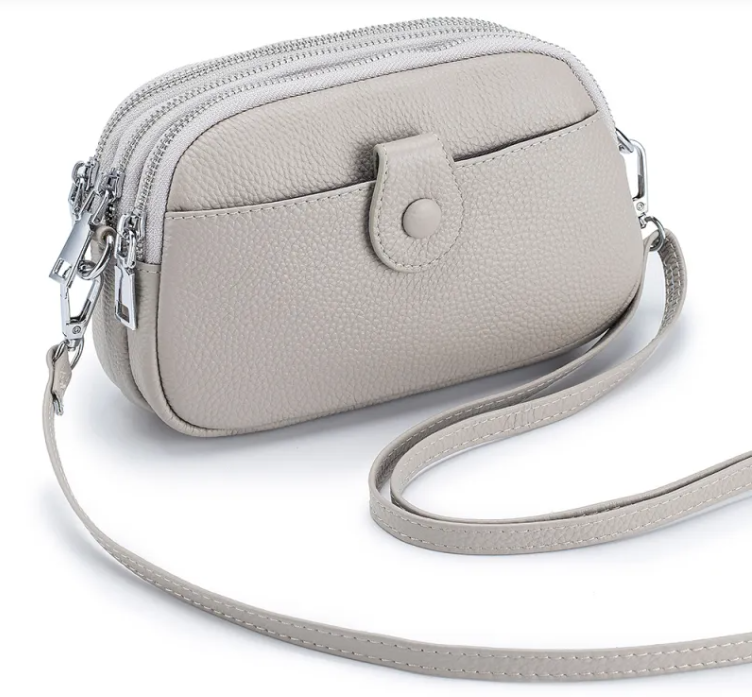 New leather fashion mobile phone bag in light gray with zipper and adjustable strap.