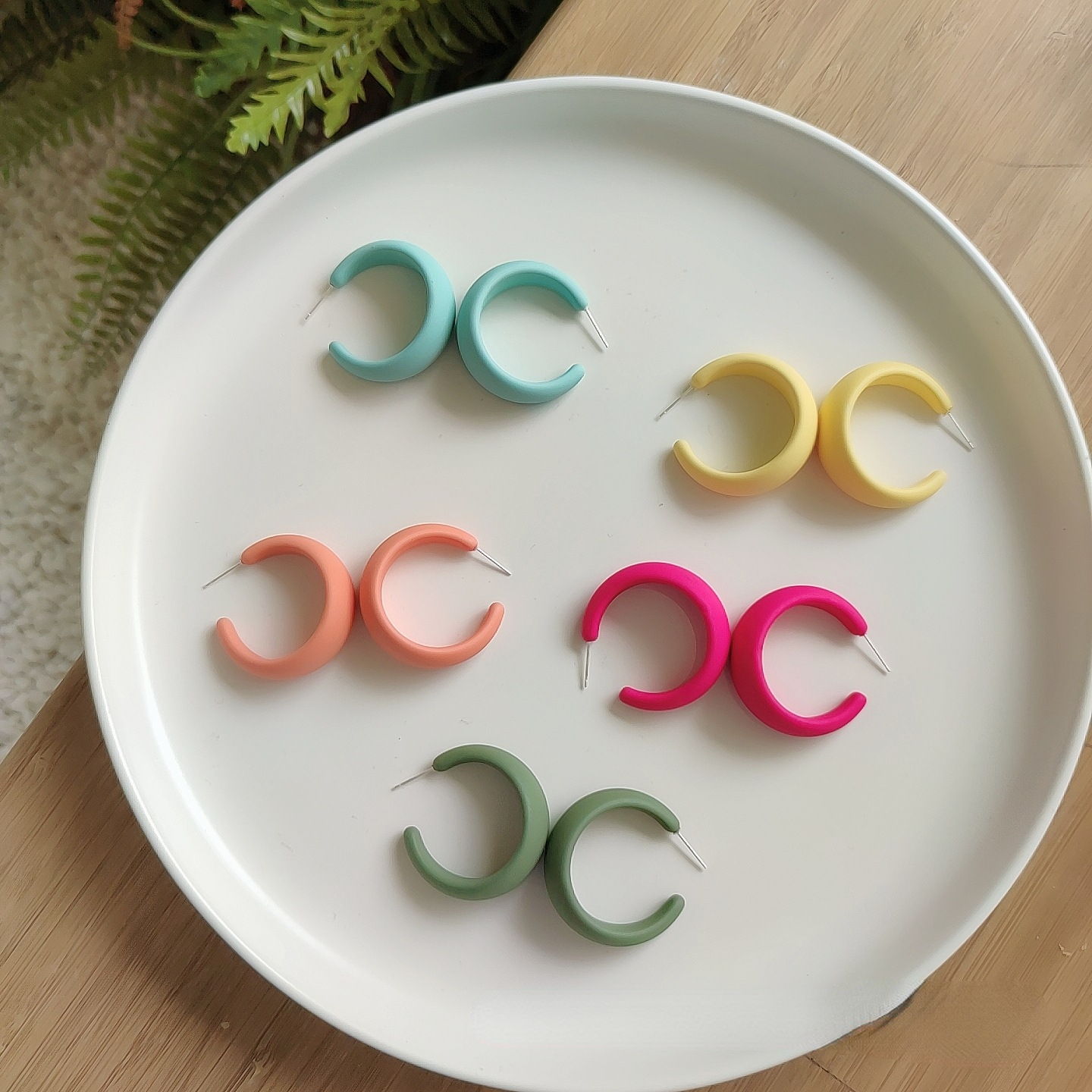 Candy color earrings for women displayed on a plate, showcasing vibrant colors for any occasion.