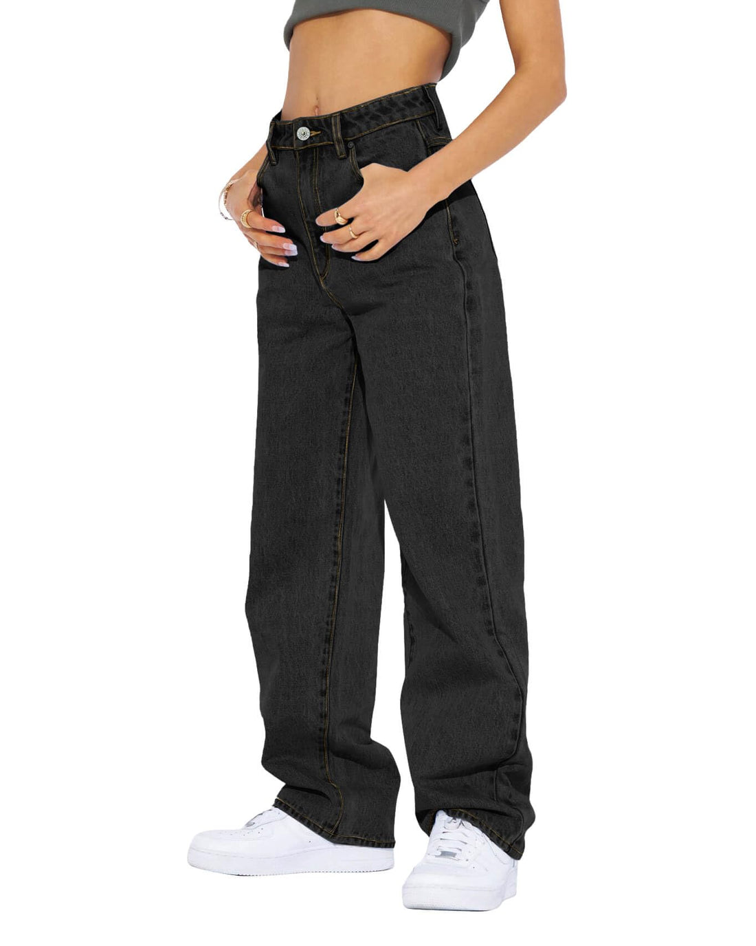 Model wearing black high waisted boyfriend jeans with a casual top and sneakers, showcasing relaxed stylish fit.