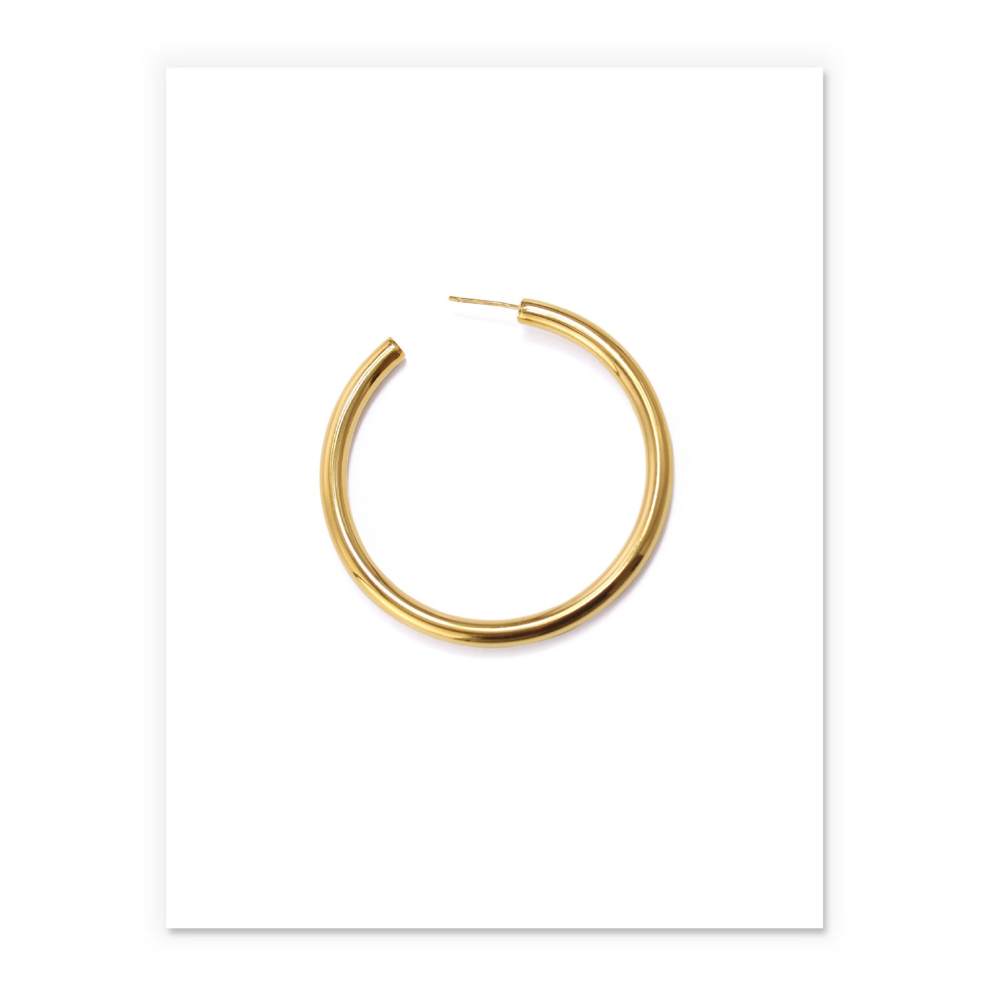 Minimalist brass hoop earrings for women in sleek gold finish, perfect for elevating any outfit.