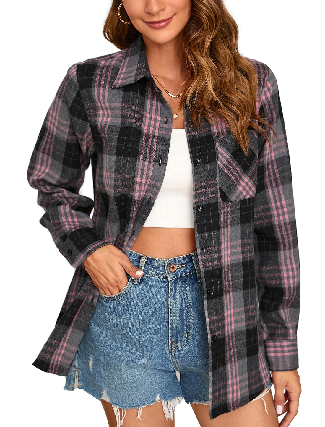 Woman wearing a pink plaid button down shirt with denim shorts, showcasing a casual outfit style.