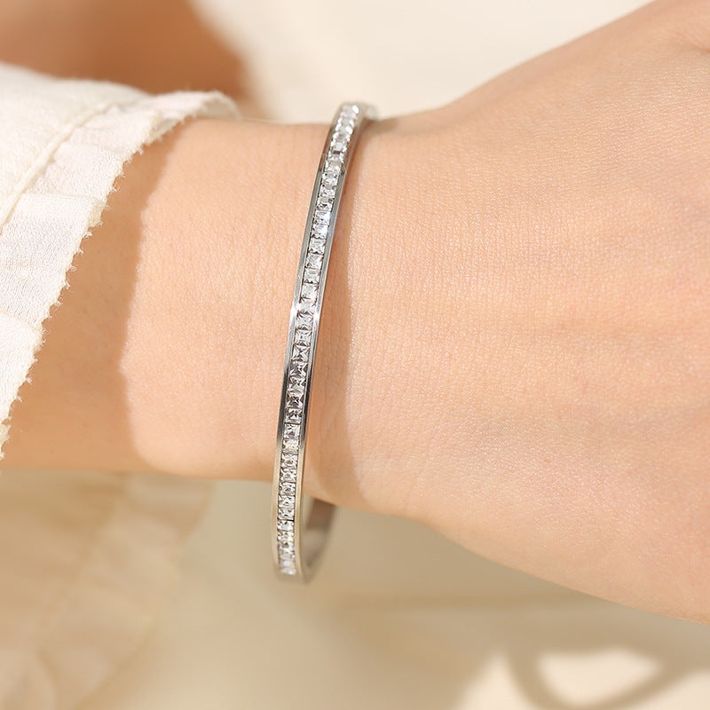 Stainless Steel Single Row Bracelet with Diamond Detail worn on wrist, showcasing stainless steel diamond bracelet design.