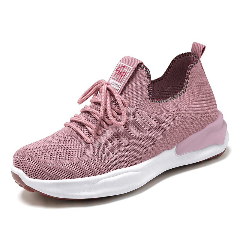 Breathable casual running shoes for women in pink color with front lace-up design and flat heel.