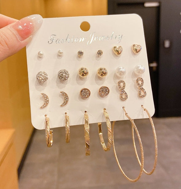12 pairs of star and moon diamond earrings set displayed on a card, featuring various designs and styles.