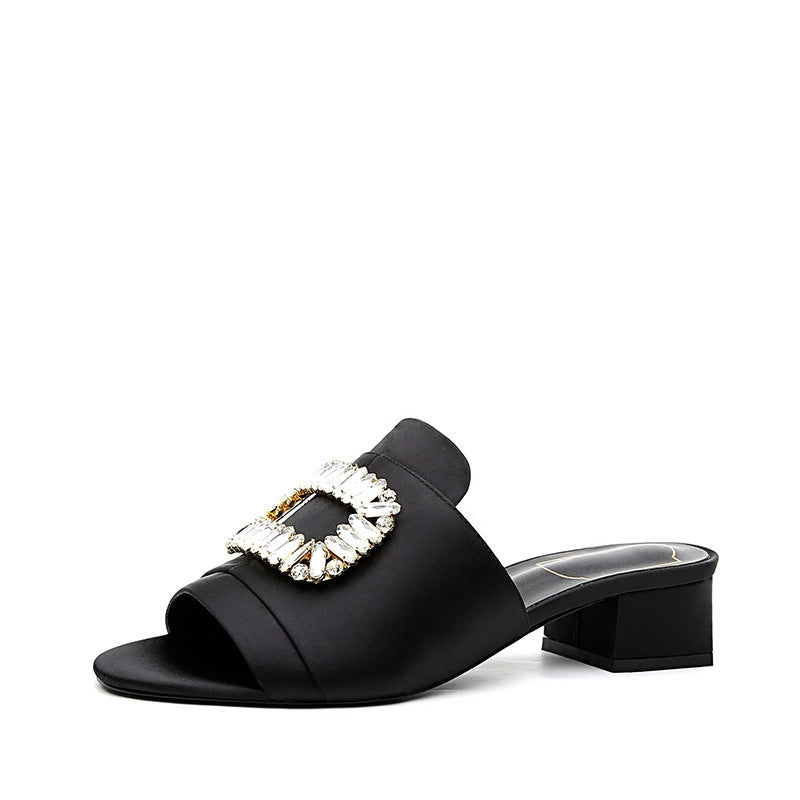 Rhinestone open-toed thick heel slippers in black with square buckle and satin finish for women.