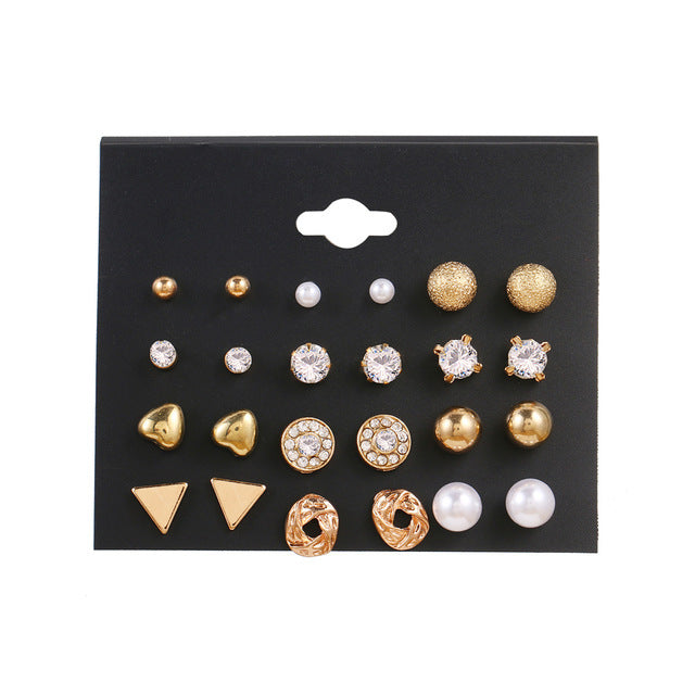 12 Pairs of Star and Moon Diamond Earrings Set displayed on a black card featuring various gold and diamond designs.