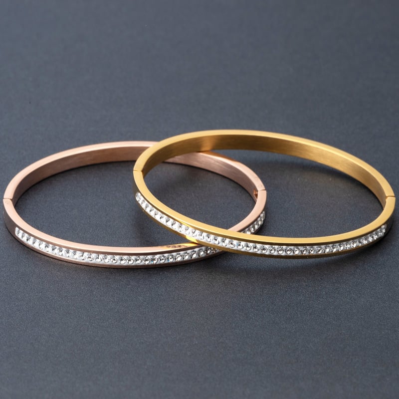 Stainless steel diamond bracelet displayed with rose gold and yellow gold finishes featuring diamond detail.