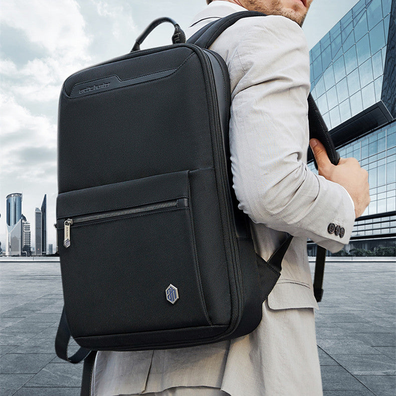 Man wearing an expandable business backpack for men in a modern urban setting.