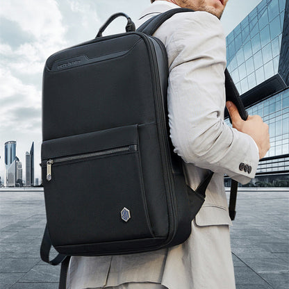 Man wearing an expandable business backpack for men in a modern urban setting.