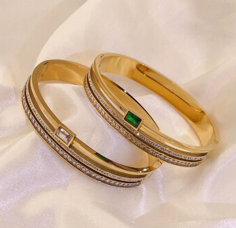 Double Row Drill Buckle Bracelet with sparkling stones and gold finish on a silk background.
