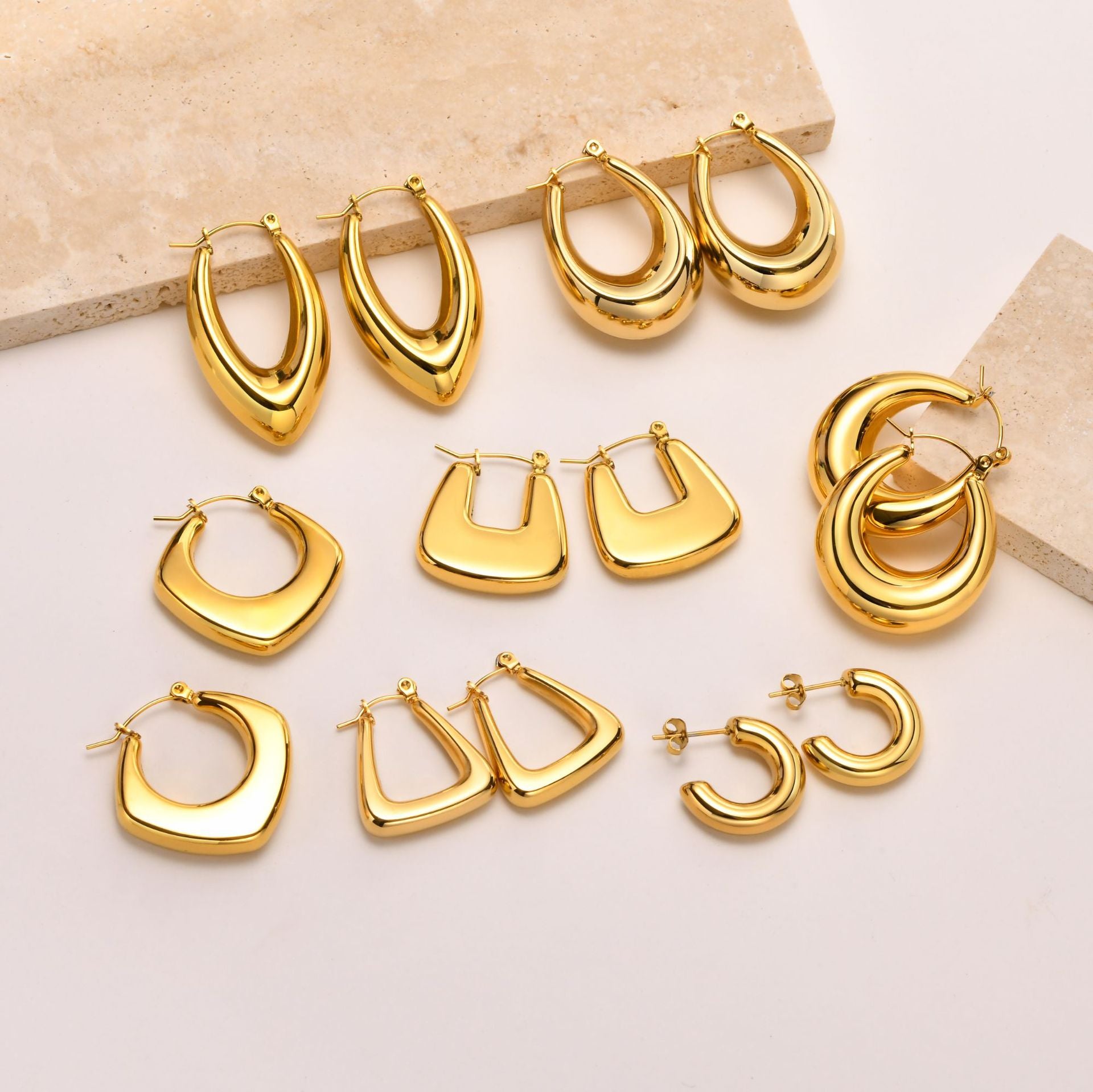 Gold hoop earrings collection, featuring various styles and shapes, perfect for enhancing fashion looks.