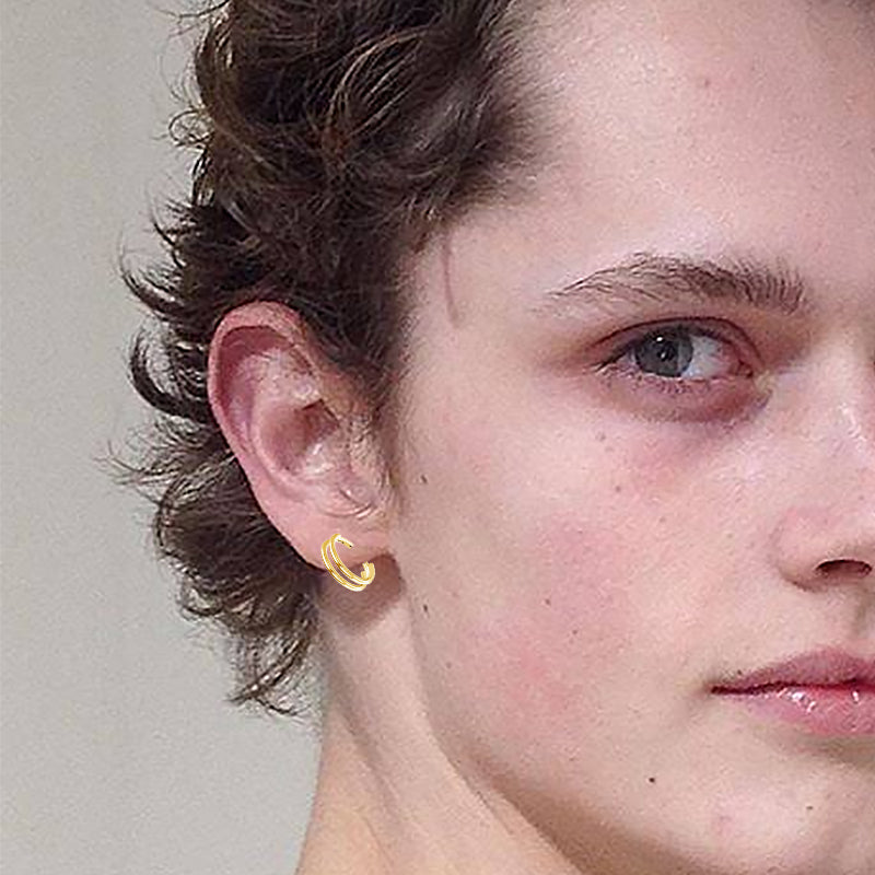 316L stainless steel nose ring worn as a cartilage earring enhancing a stylish look.