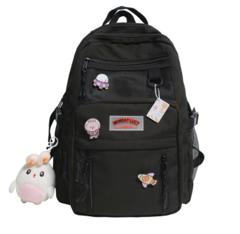 High-capacity backpack for students in black with cute patches and keychain decorations.