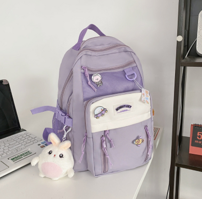 Purple high-capacity backpack for students with multiple compartments and cute patches, perfect for school essentials.