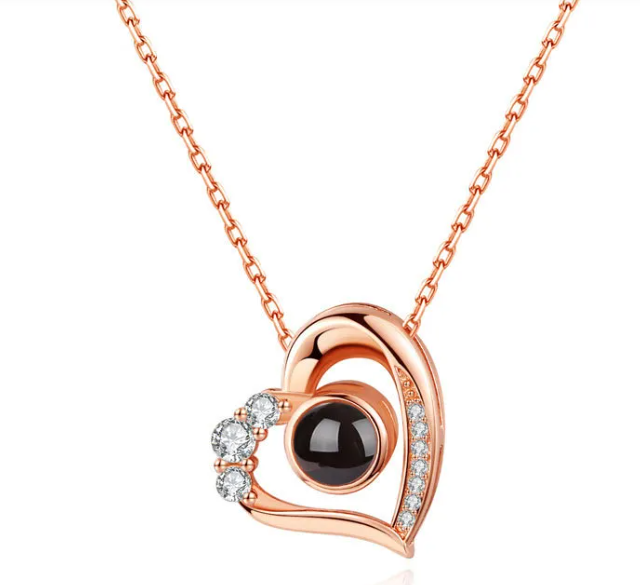 silver geometric pendant necklace in a heart design with black and crystal embellishments
