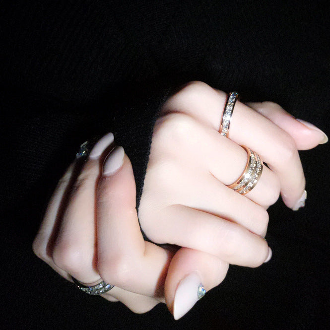 Double row zircon stainless steel ring for women showcased on elegantly manicured hands.