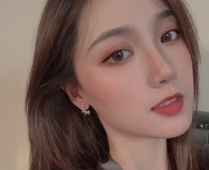 Modern woman wearing daily wear zirconia stud earrings, showcasing elegance and versatility in her style.