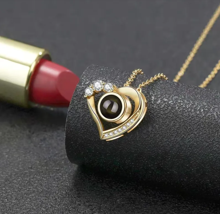Silver geometric pendant necklace featuring a heart design and embellished with sparkling diamonds.