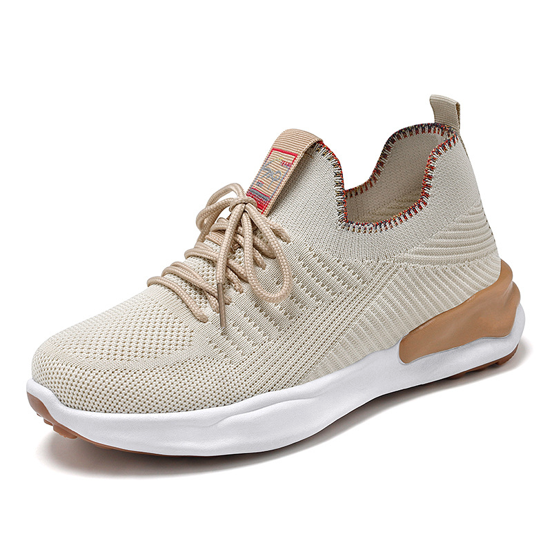 breathable casual running shoes for women in beige color with round toe and front lace-up design.