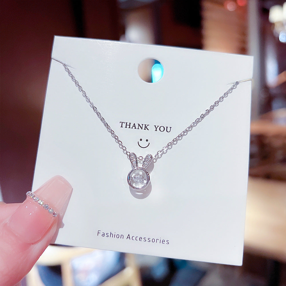 Elegant titanium steel bunny necklace displayed on a card with &