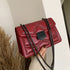Black chain shoulder messenger bag for women in red, featuring a stylish lock closure and studded design.