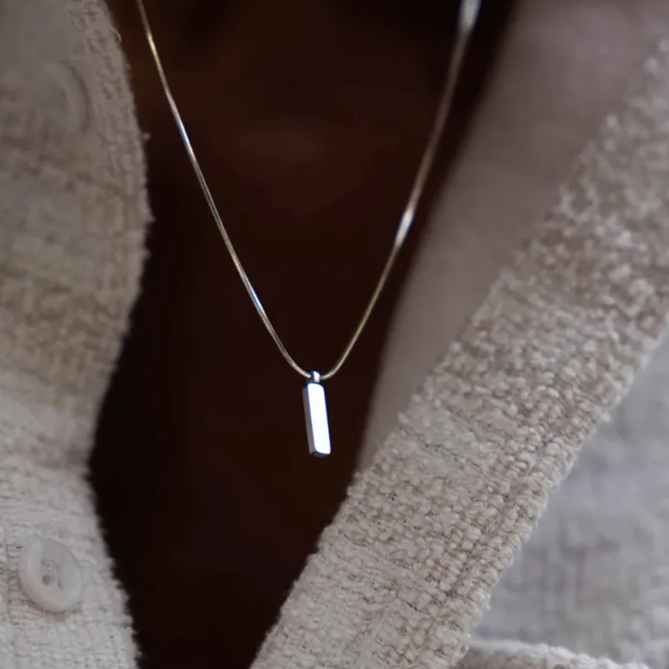 Stainless Steel Clavicle Chain Necklace featuring a minimalist design on a textured garment.