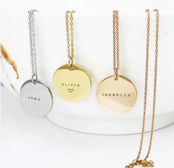 Personalized stainless steel clavicle chain necklaces displaying names on pendants.