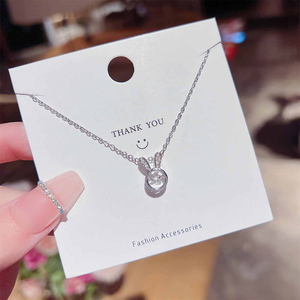 Titanium steel bunny necklace with rabbit design, showcasing elegant simplicity on a thank you card.